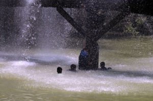 Youth Bathes in Leaking Canal Water Amid Intense Heatwave