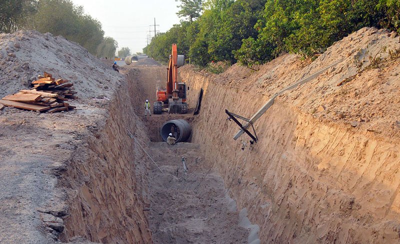 Laborers Excavate Trench for Sewerage Pipeline on NLC Bypass