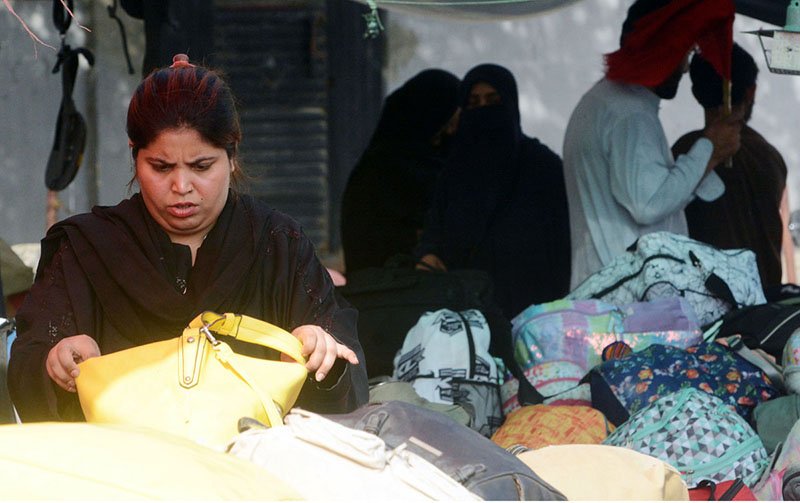 Woman Shops for Used Handbags at Karachi’s Empress Market
