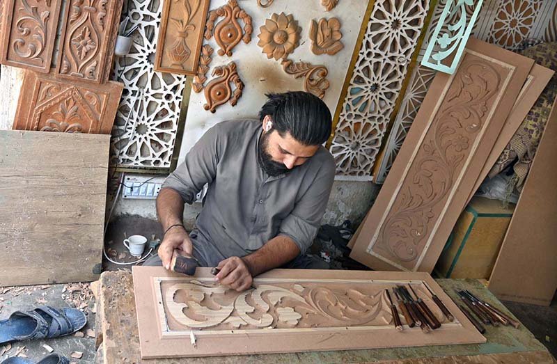 Artisan Crafts Intricate Designs on Metal Sheets in Rawalpindi Workshop