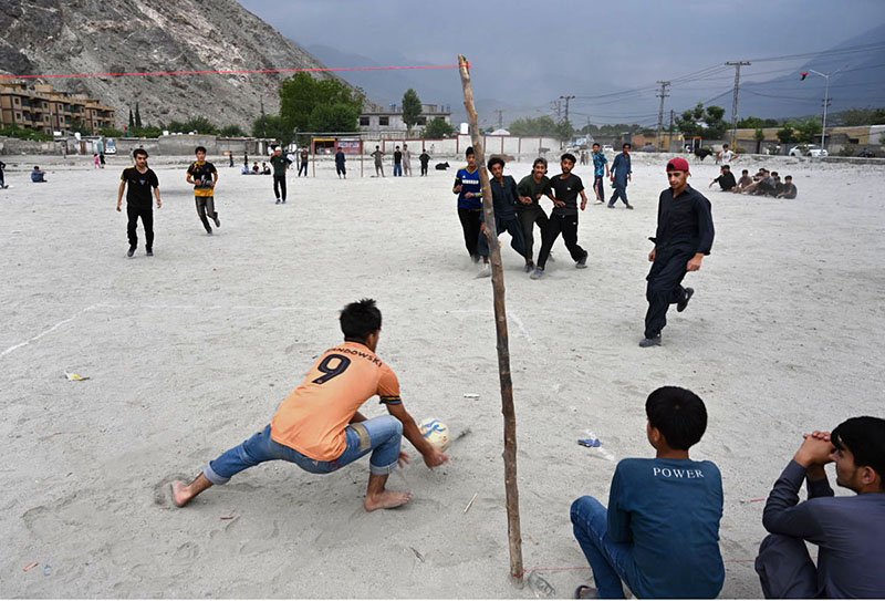 Youth Football Match in Gilgit Amidst Majestic Mountain Backdrop
