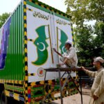 Truck Art Painter Crafts Pakistani Flag on Peshawar Delivery Truck