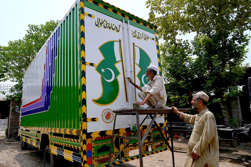 Truck Art Painter Crafts Pakistani Flag on Peshawar Delivery Truck