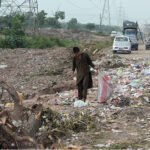 Child Collects Recyclables from Roadside Garbage in Islamabad