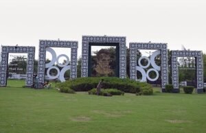 Gardener Maintains Faisal Avenue Green Belt Featuring Jinnah Portrait