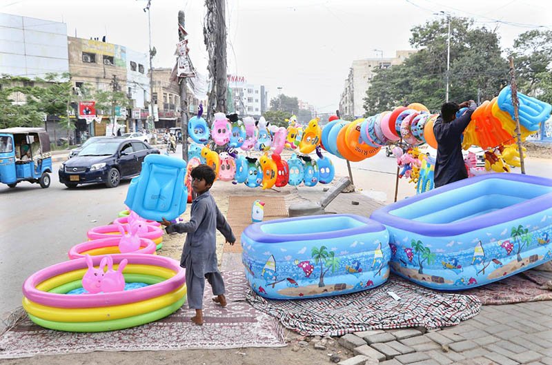 Vendor Sets Up Roadside Sale of Children’s Toys and Pools